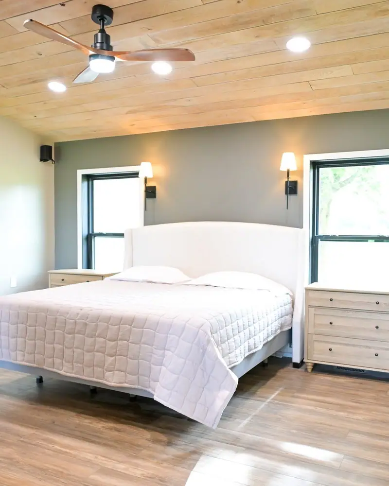 Wheelchair-accessible addition in Salisbury, MO: bedroom with LVP floors and black-framed windows