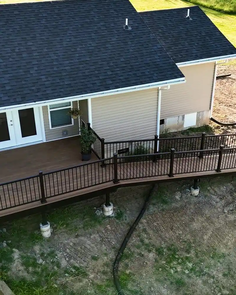Accessible composite deck with black railings on a home addition in Salisbury, MO