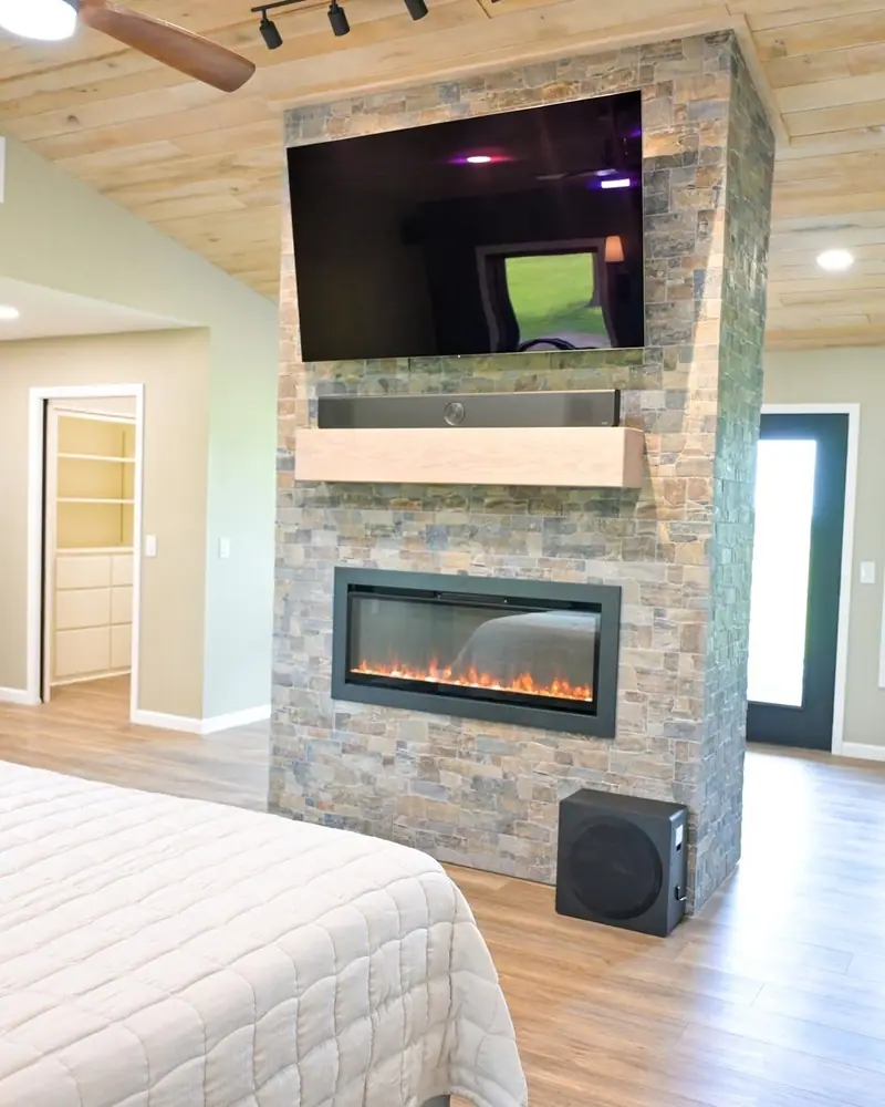 Wheelchair-accessible addition in Salisbury, MO: stone fireplace wall in the primary suite