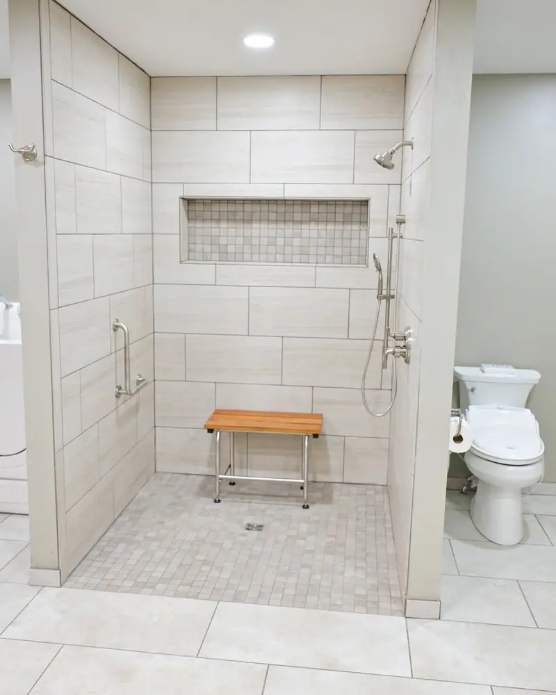 ADA roll-in shower in Salisbury, MO: curbless tile shower with bench, grab bar, and handheld shower