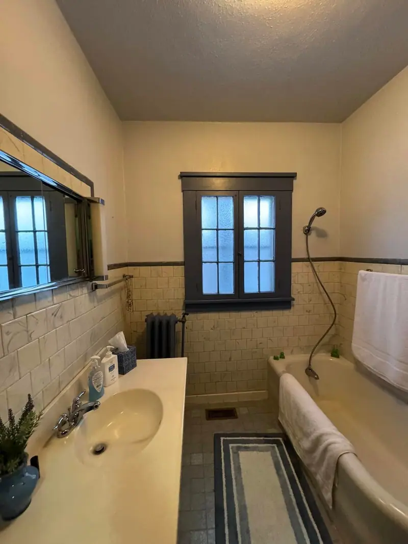 Bathroom remodel in Salisbury, MO, before: old wall tile and a tub