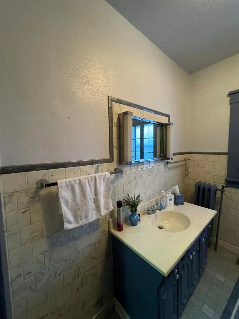Bathroom remodel in Salisbury, MO, before: old vanity and tile wall