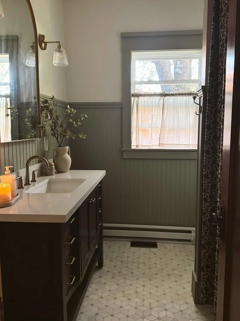 Bathroom remodel in Salisbury, MO: beadboard wall, window, and hex tile floor