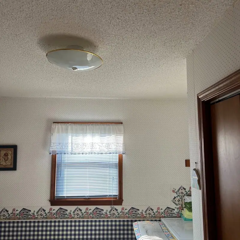 Popcorn ceiling removal in Bynumville, MO, before: textured ceiling and old light