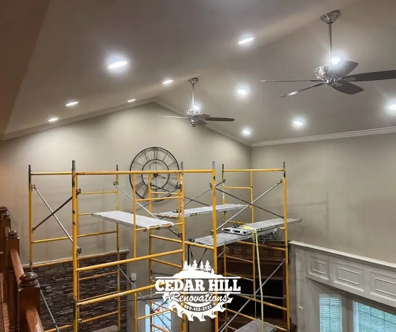 Crown molding installation in progress in a vaulted great room in Salisbury, MO