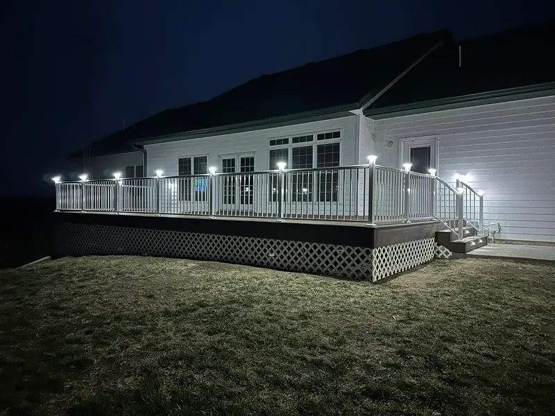 Composite deck with lighted post caps at night in Salisbury, MO