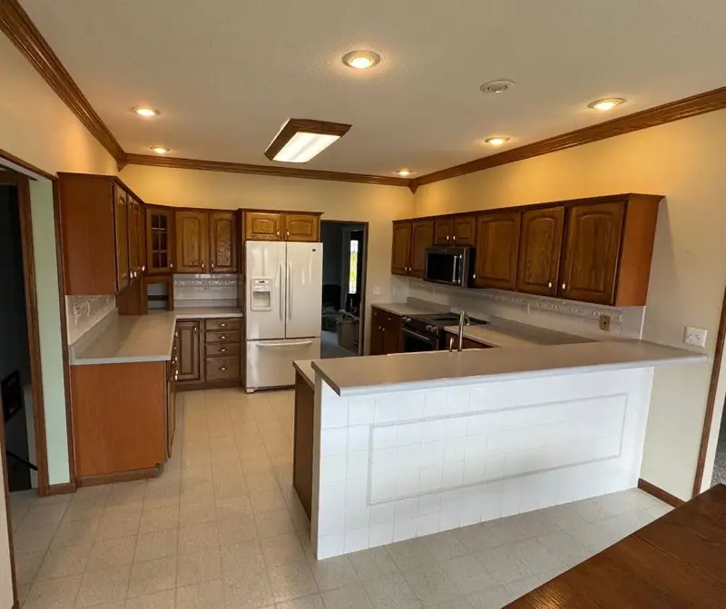 Kitchen remodel in Keytesville, MO, before: laminate counters and vinyl floors