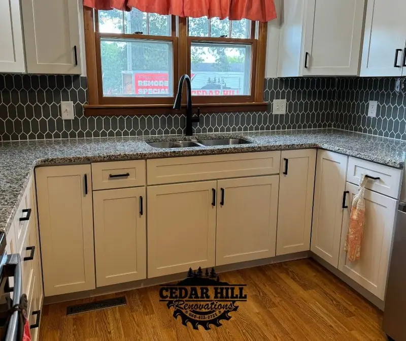 Kitchen remodel in Salisbury, MO, after: white shaker cabinets, granite counters, and hexagon tile backsplash