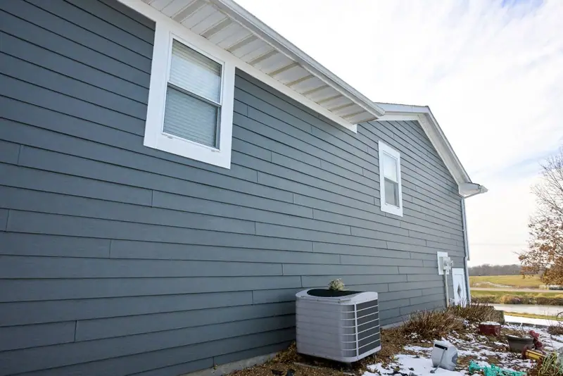 Siding replacement in Brunswick, MO, after: side of the house in gray lap siding