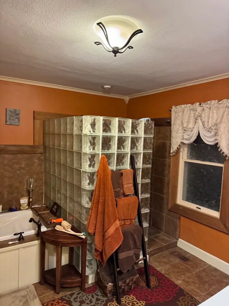 Whole-home remodel in Salisbury, MO, before: bathroom with a glass block shower