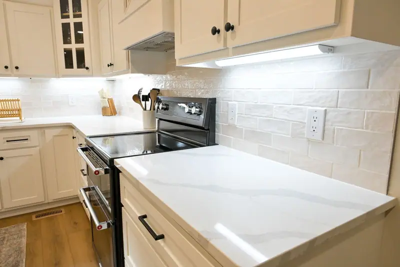 Whole-home remodel in Salisbury, MO: quartz counter, subway tile, and under-cabinet lighting
