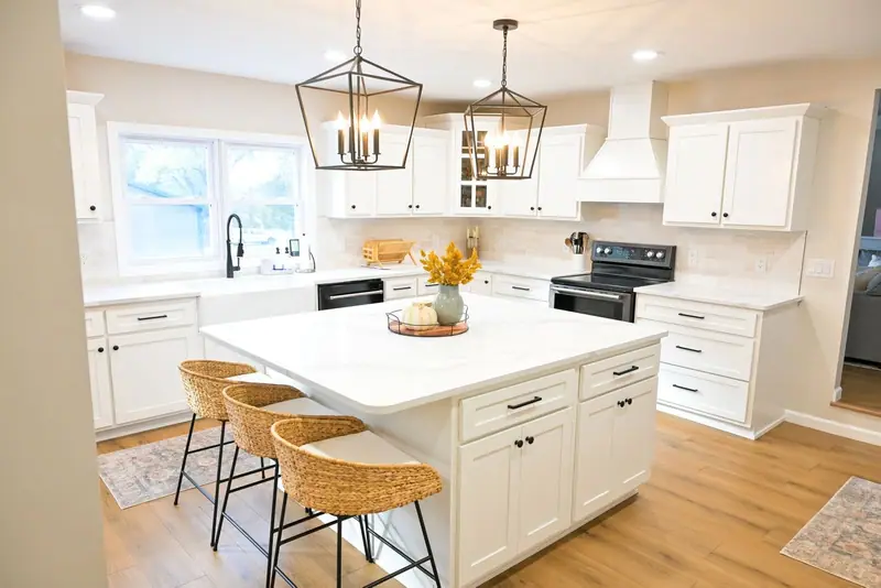 Whole-home remodel in Salisbury, MO: kitchen island with woven stools and wood-look LVP floors