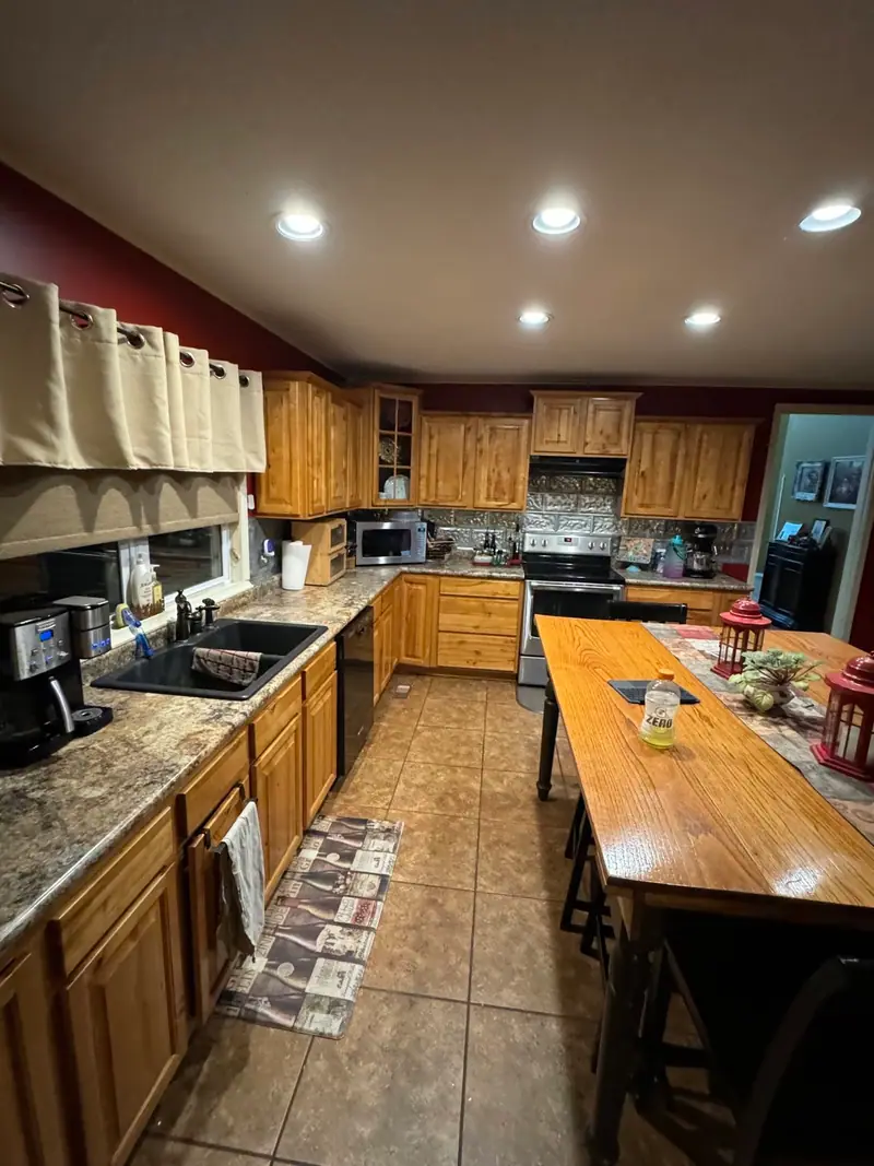 Whole-home remodel in Salisbury, MO, before: original kitchen with wood cabinets