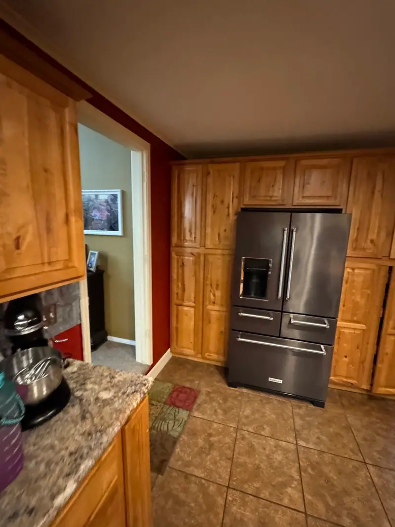 Whole-home remodel in Salisbury, MO, before: knotty wood kitchen cabinets