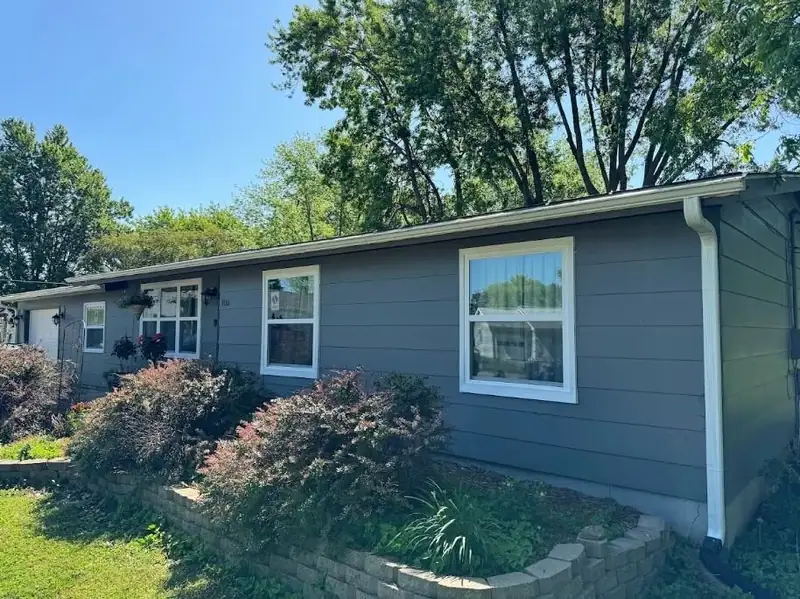 Window replacement in Salisbury, MO: new white windows on a gray ranch home